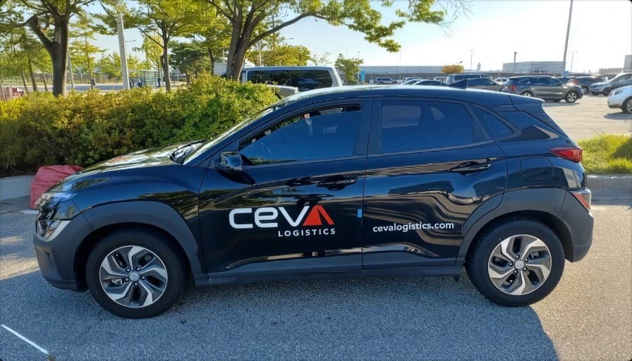 A CEVA Logistics branded vehicle parked outside a facility