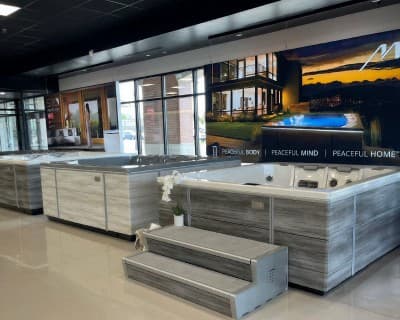 A showroom catalogue display with product accessory panels mounted on a slatted wood wall.