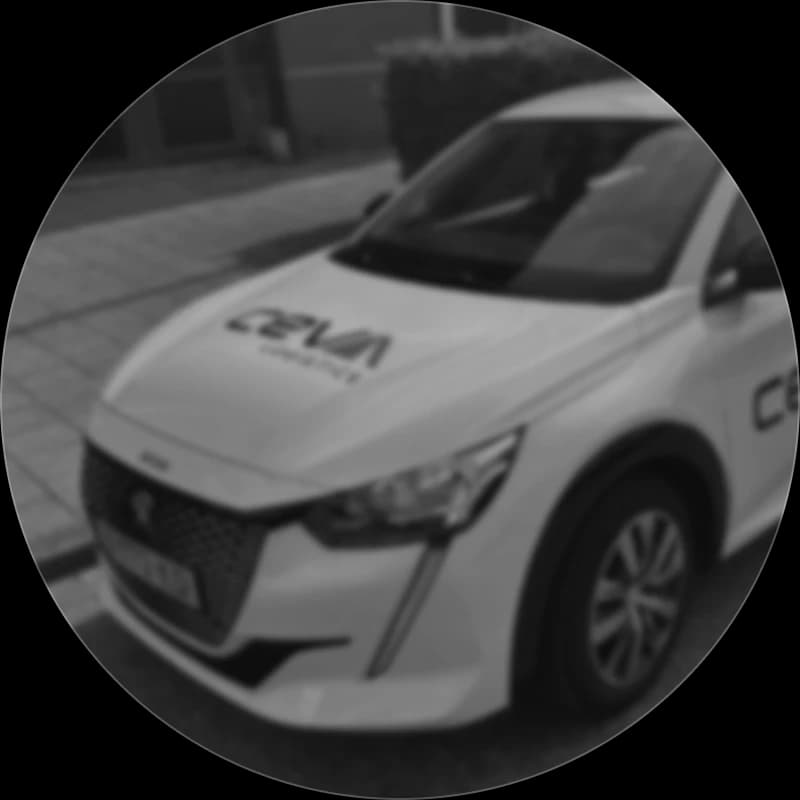 A CEVA Logistics branded electric company car parked at the curb