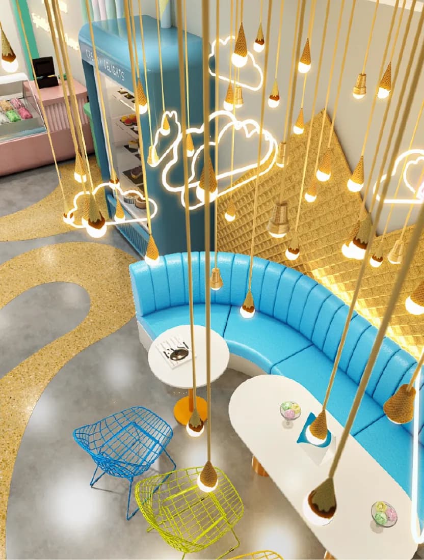 An ice cream parlor interior with gold pendant lights hanging over a curved blue banquette